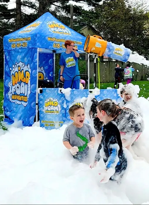Kids playing in foam at a Wild Foam Adventures party