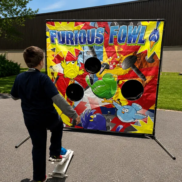 A child playing the Furious Fowl target game