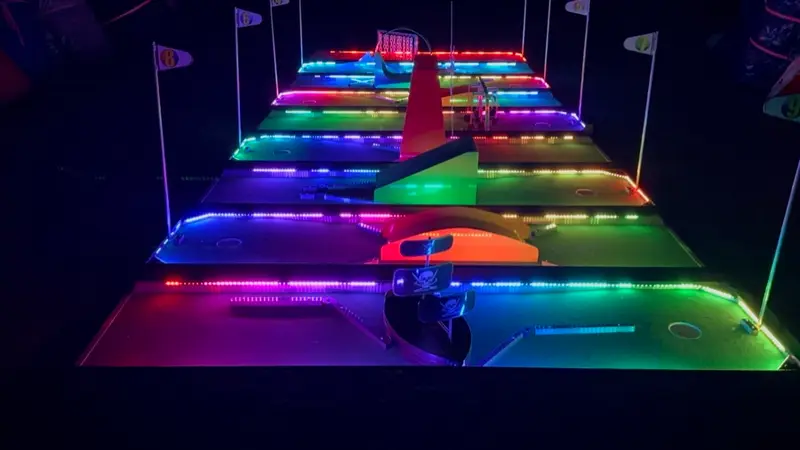 The mobile mini golf course lit up at night